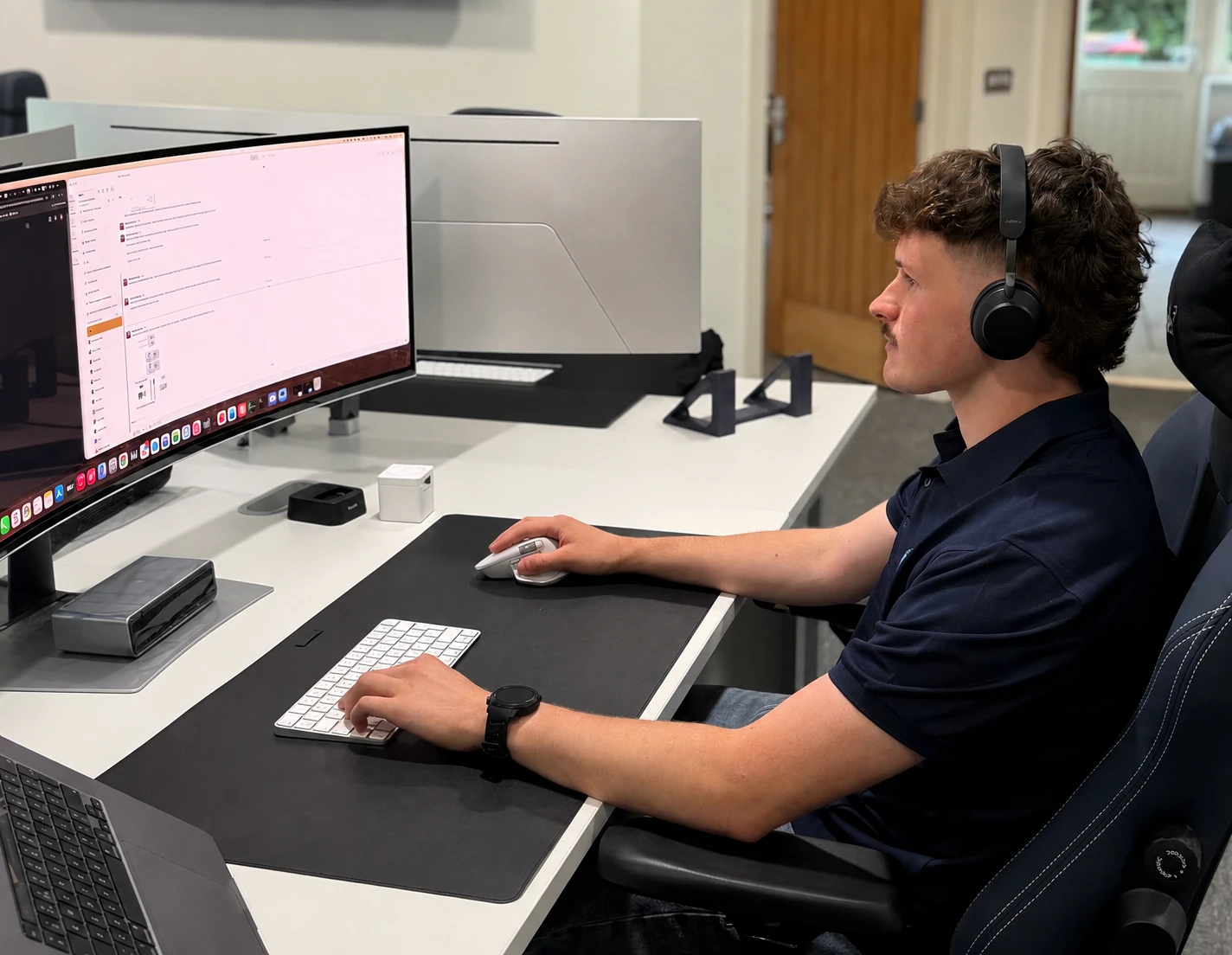 A We C2 IT security engineer monitoring systems at their desk