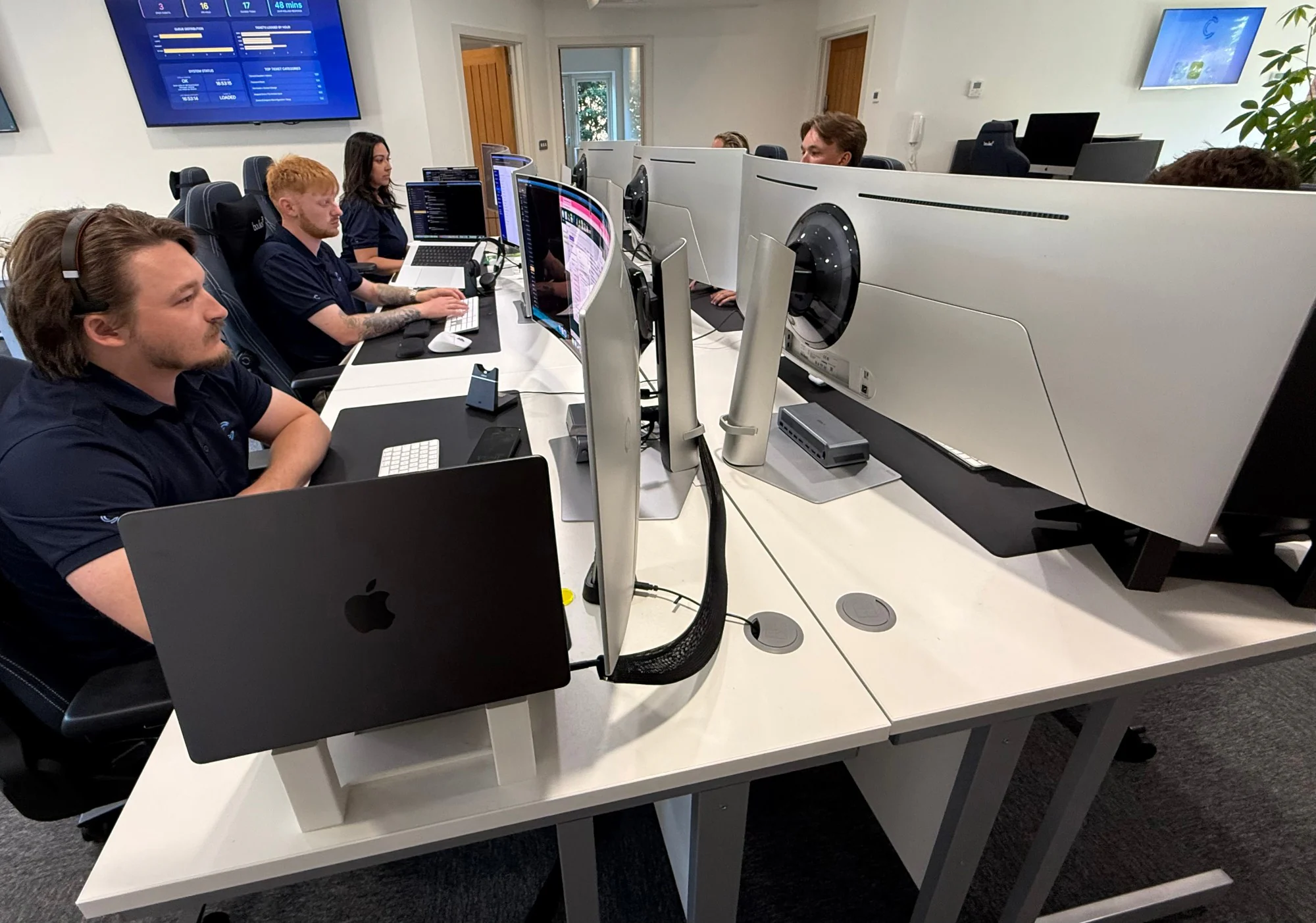 The We C2 IT engineering team at the service desk