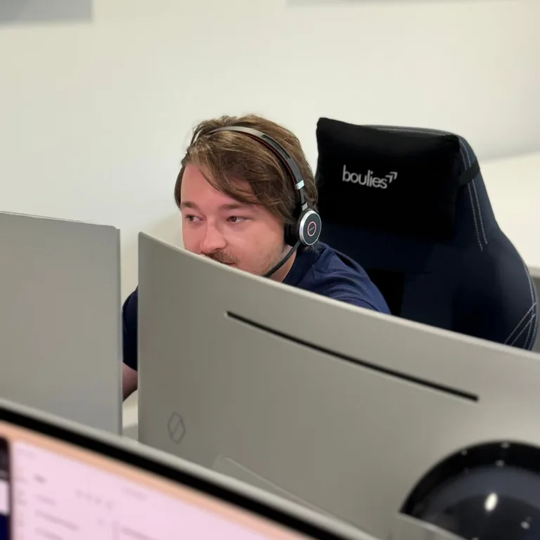 A We C2 IT engineer taking a support call at the service desk